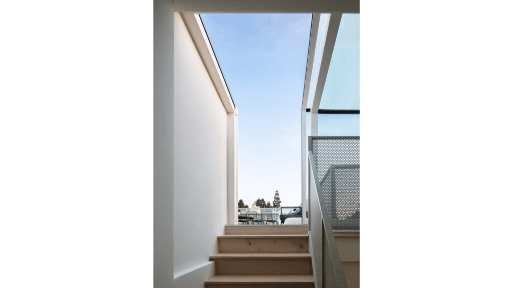 Looking up the stairs view, to an open door of our three wall Skybox with a horizon view.