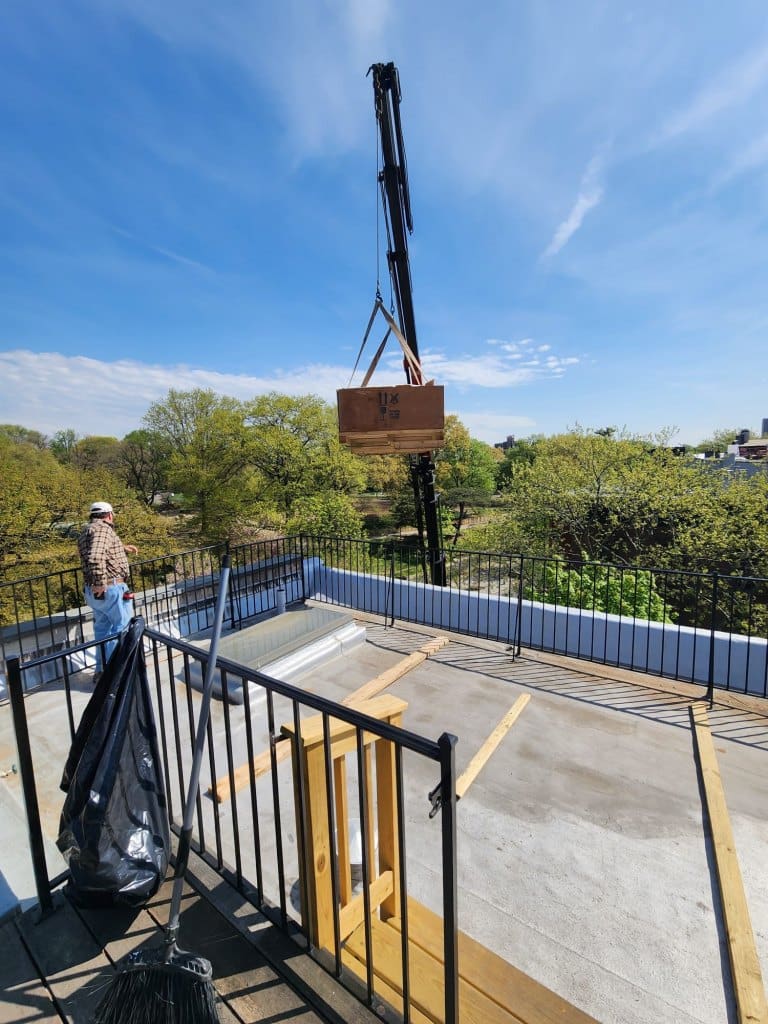 The Glazing Vision Skydoor installation process, a crane was used to lift the roof deck access door onto the roof